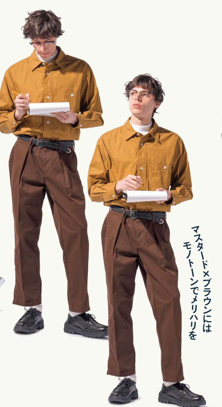 two men in brown pants are holding papers and looking at the same person's face