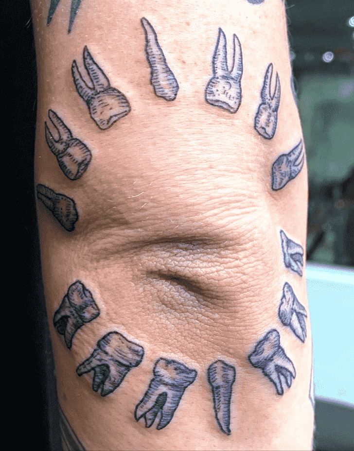 a man's arm with tattoos on it showing different types of footnails