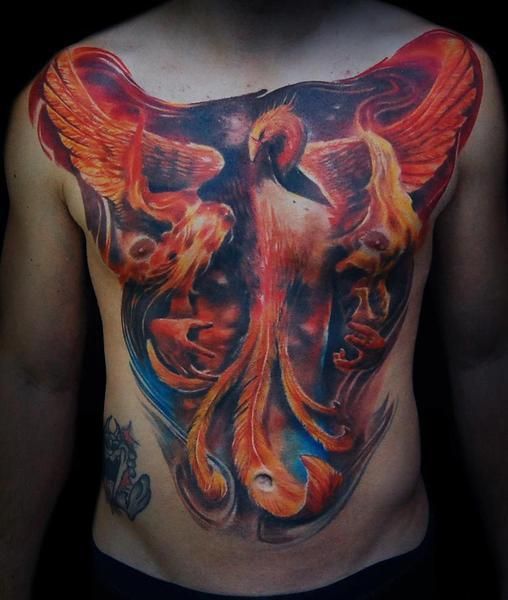 a man's chest with an artistic tattoo on it