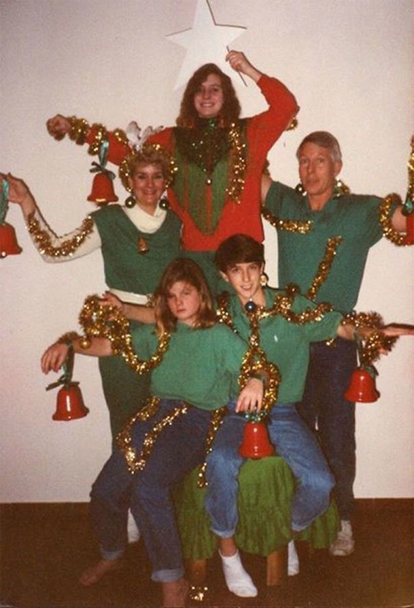 a group of people posing for a photo with christmas decorations on their arms and legs