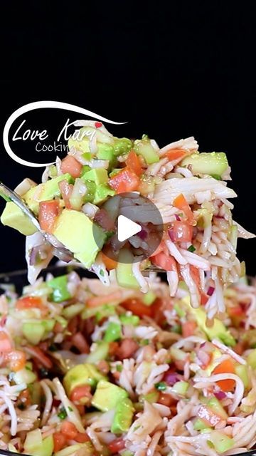 a bowl filled with rice and vegetables on top of a table