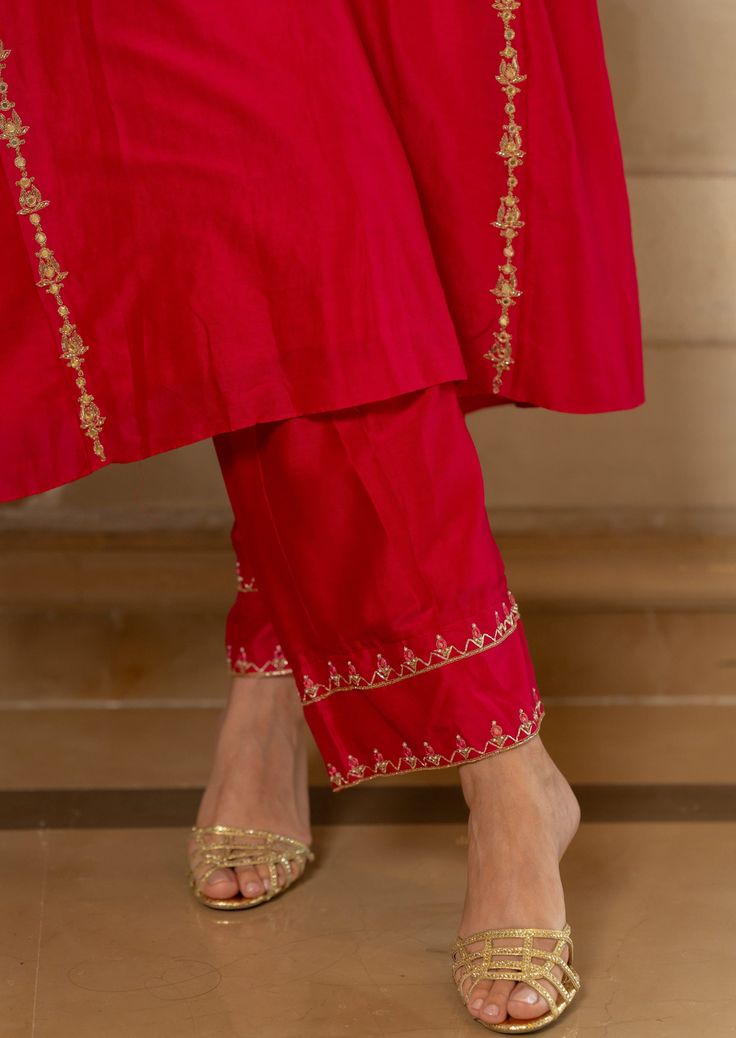 Featuring rani pink chiniya silk kurta set paired with hand embroidered detailed pants. Yoke is highlighted with anar motif using antique gold handwork. Designer Raw Silk Palazzo Set With Dori Work, Pink Slub Silk Palazzo Set With Zari Work, Traditional Slub Silk Palazzo Set With Resham Embroidery, Silk Palazzo Set With Resham Embroidery For Diwali, Festive Slub Silk Palazzo Set With Gota Work, Gold Embroidered Slub Silk Sets, Eid Straight Kurta With Resham Embroidery, Pink Slub Silk Set With Dori Work, Eid Resham Embroidery Kurta With Straight Pants