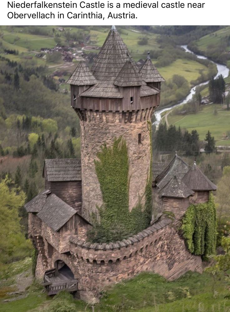 an old castle with ivy growing on it's walls and roof, surrounded by green hills