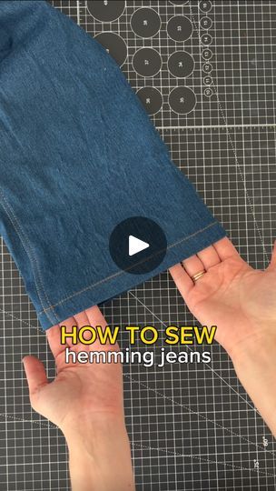 someone is holding their jeans in front of the camera and pointing at it with both hands