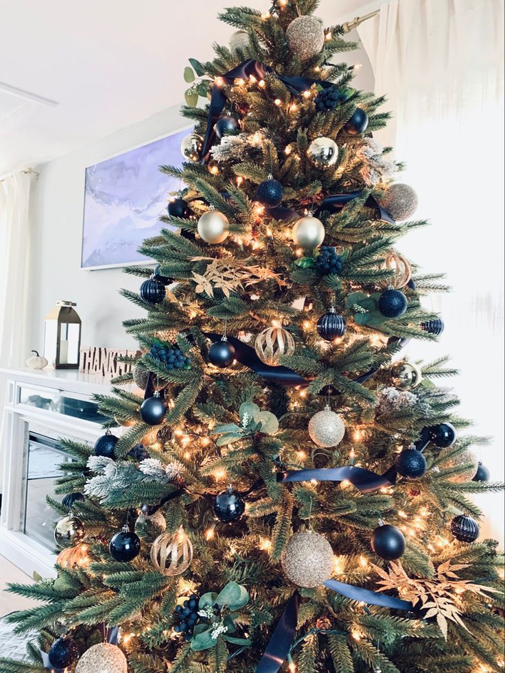 a decorated christmas tree with blue and gold ornaments