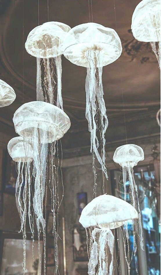 there are many jellyfish hanging from the ceiling