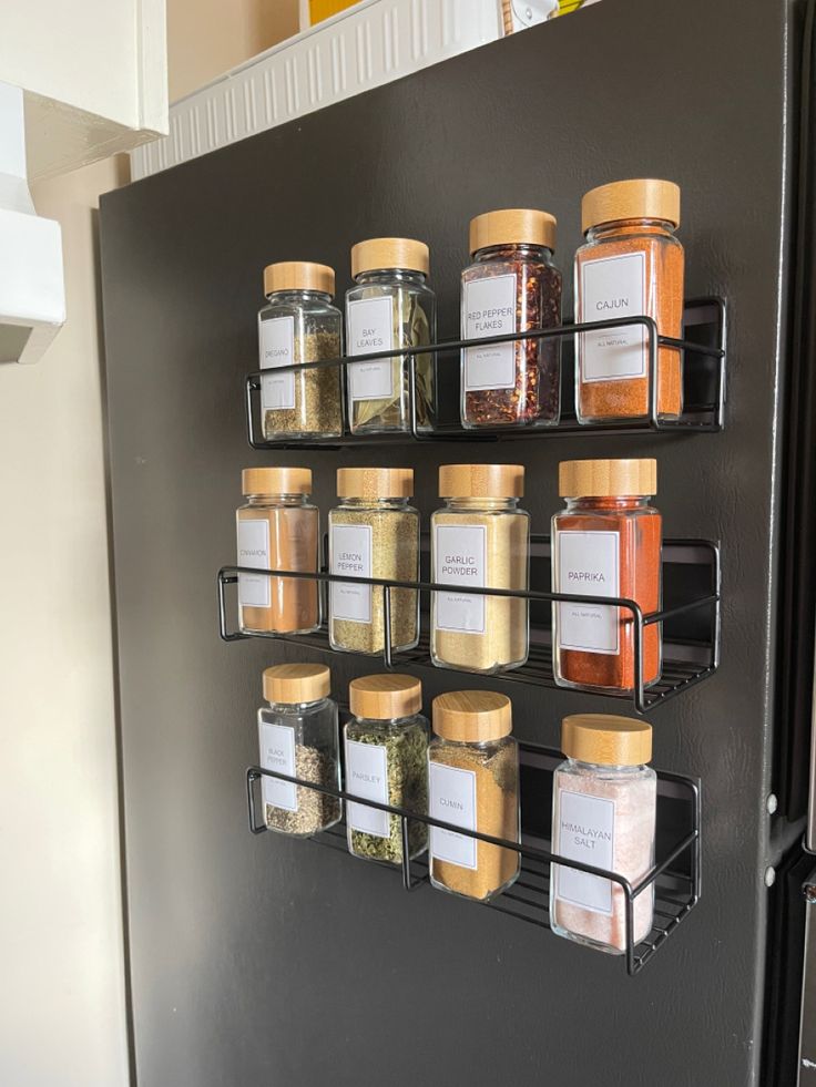 the spice rack is organized with spices and seasonings on it's side wall