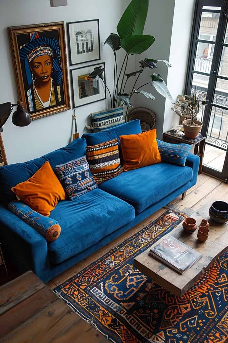 a living room with blue couches and rugs in front of large windows overlooking the city