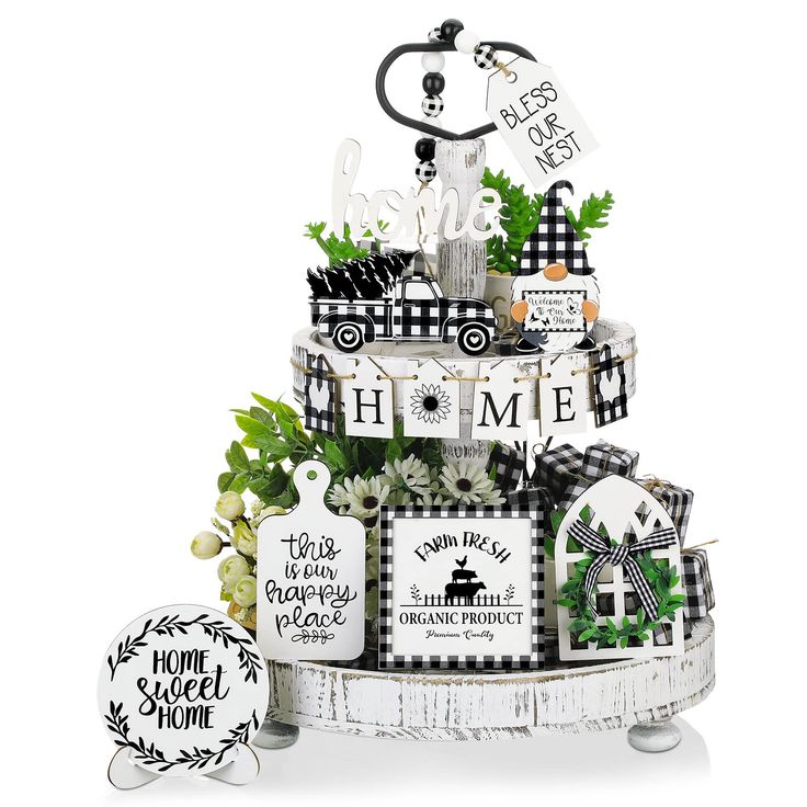 a tiered cake decorated with black and white items for the home decorating contest