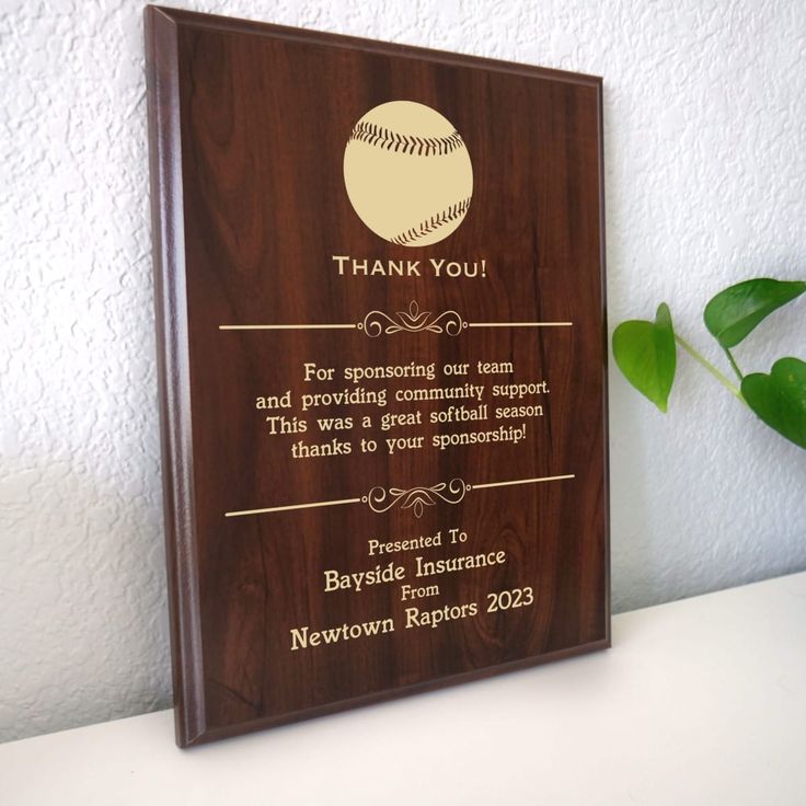 a wooden plaque with a baseball on it that says, thank you for supporting our team and providing community support