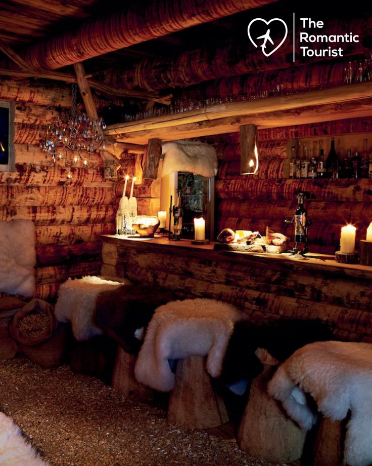 an old fashioned log cabin with fur and candles