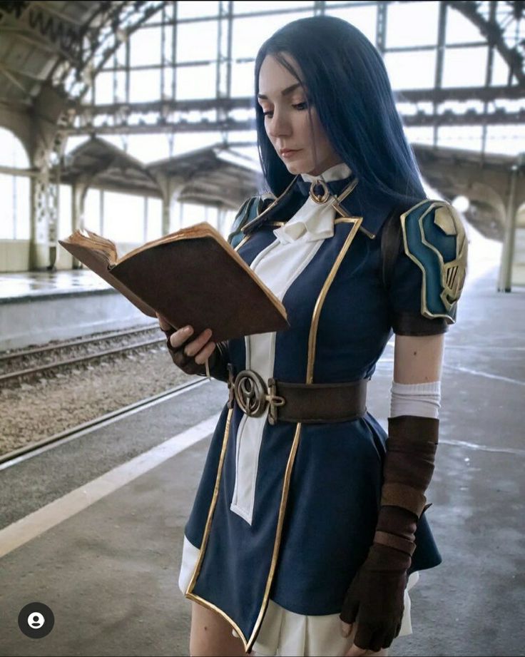 a woman dressed in blue and white holding a book