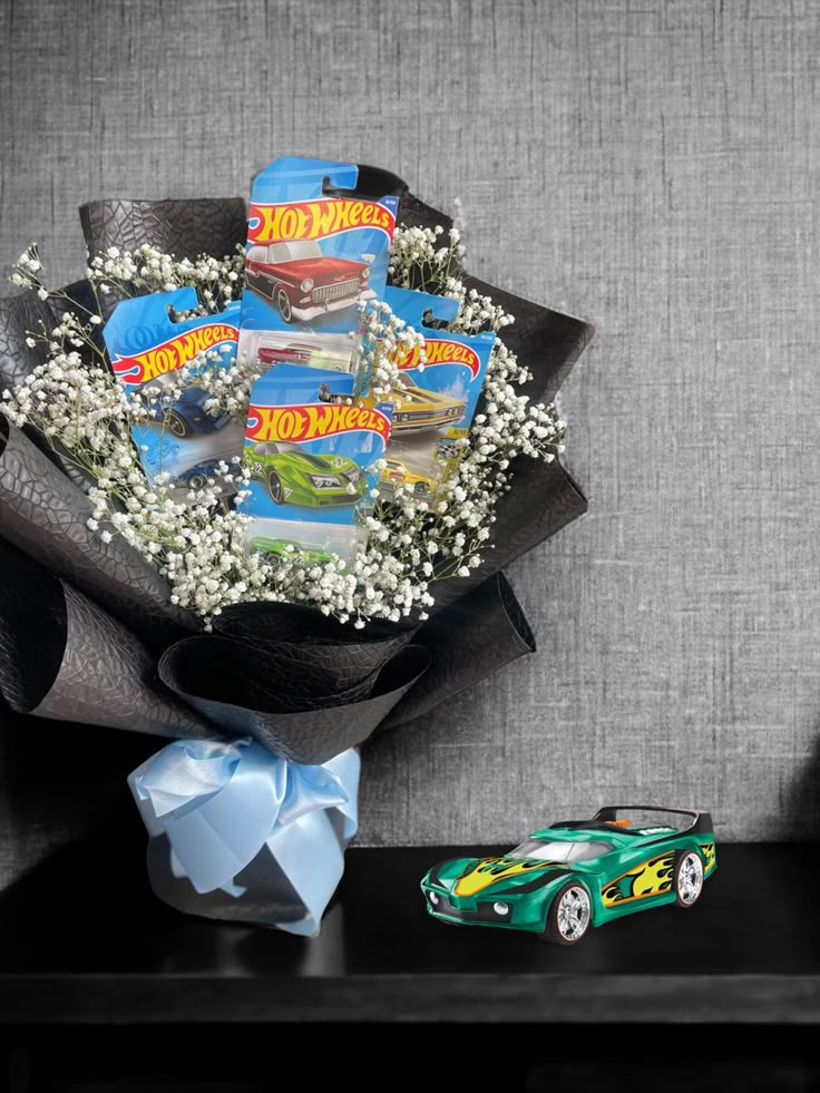 a bouquet of baby's breath and hot wheels are sitting on a shelf