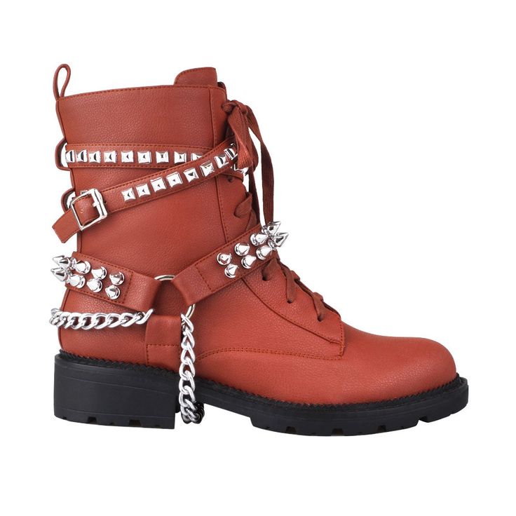 These vibrant and stylish boots will let you enter the world with style. These privileged boots, which are made of vegan leather and adorned with chains and studs, will stand out and provide an edgy edge to any ensemble. They are the ideal choice to transition your outfits from day to night, with an ankle buckle closure for a snug fit and a 1.5"H heel. These fashionable boots are ideal for wearing with jeans or skirts and are sure to draw attention. With these shoes, you'll undoubtedly feel pamp Trendy Synthetic Boots With Medium Width, Trendy Medium Width Synthetic Boots, Trendy Winter Heels With Round Toe, Spring Streetwear Round Toe Heels, Trendy Fall Heels, Trendy Medium Width Heels For Fall, Trendy Spring Heels With Lug Sole, Trendy Lug Sole Heels For Spring, Trendy Summer Faux Leather Boots