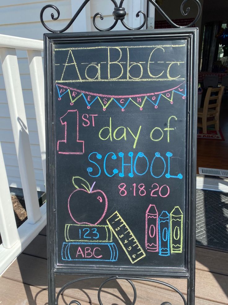 a chalkboard sign that says 1st day of school