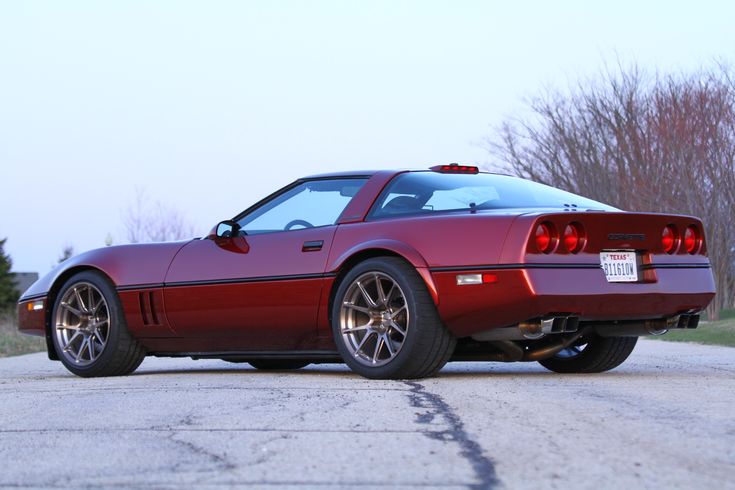 a red sports car is parked on the street