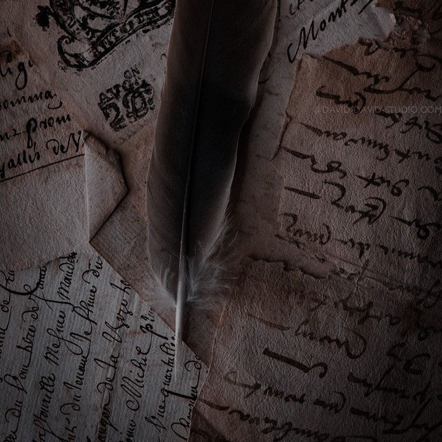 an old paper with writing on it and a feather quill resting on the top