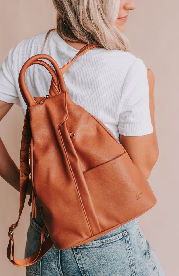 We are always looking for a bag that everyone will love. This might just be it! Enter our convertible backpack. This bag comes with a stylish clever zipper strap, it goes from backpack to crossbody, has a convenient top handle and can even be wore on the shoulder. It's the middle ground between our Hazel and Nikki. Yes, this bag is just that good!! Bag Details: Made with Premium Vegan Leather Dims: 11" BASE 4" TOP W X 13.5" H X 5.5" D Weight: 1.12 lbs. Exterior Features: 1 Front Padded Pocket 1 Everyday Backpack With Double Handle And Zipper Closure, Everyday Leather Softback Backpack With Detachable Strap, Everyday Leather Tote Backpack With Zipper, Softback Leather Backpack With Detachable Strap, Leather Softback Backpack With Detachable Strap, Softback Leather Backpack With Detachable Strap For Everyday Use, Versatile Tote Backpack With Zipper Closure, Trendy Backpack Satchel For Everyday Use, Fall Backpack With Adjustable Strap