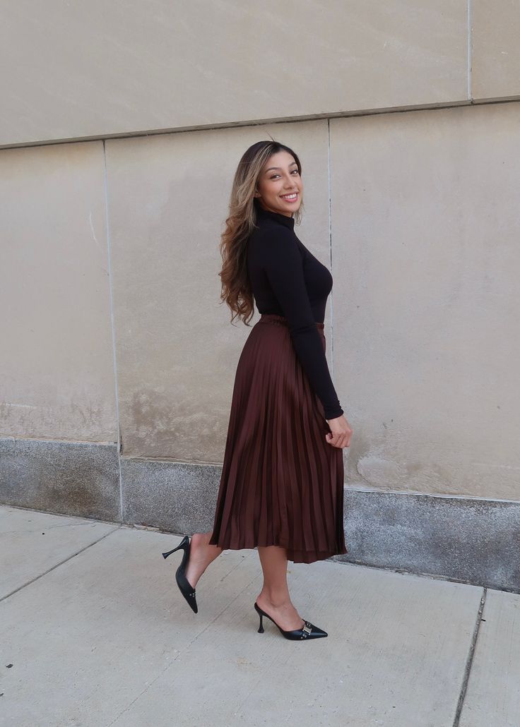 PRODUCT DETAILS: Dark brown pleated skirt Satin Midi length Elastic waistband True to size 100% Polyester Model is wearing a size Small Model Info: Height: 5'3", Bust: 36 3/4". Waist: 30", Hips: 38.5" MEASUREMENTS: Length: 31" Small: Waist: 13" Medium Waist: 14" Large Waist: 15" Pleated Skirt Bottoms For Fall Date Night, Fall Date Night Pleated Skirt Bottoms, Pleated Skirt For Night Out In Fall, Elegant Brown Skirt For Date Night, Accordion Pleated Skirt For Fall, Pleated Bottoms For Night Out In Fall, Fall Pleated Bottoms For Night Out, Elegant Brown Full Skirt Bottoms, Brown Party Bottoms With Flowy Fit