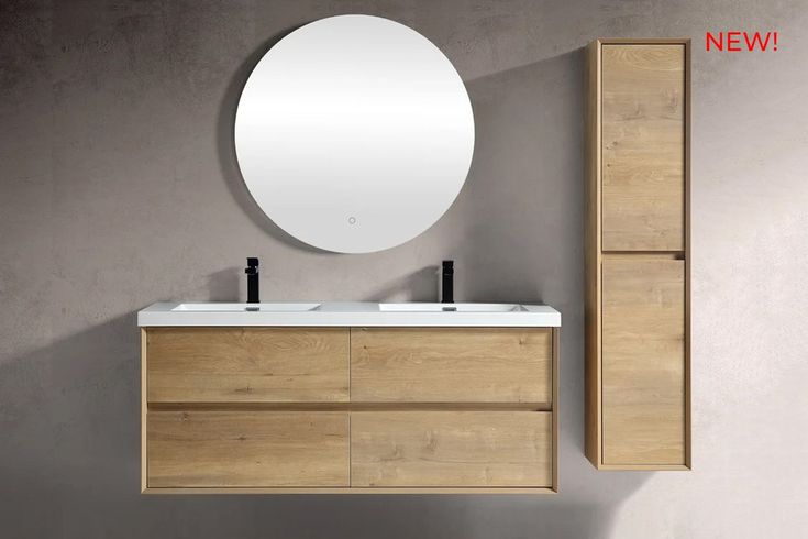 a bathroom vanity with two sinks and a round mirror on the wall next to it