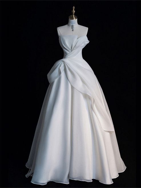 a white wedding dress on a mannequin