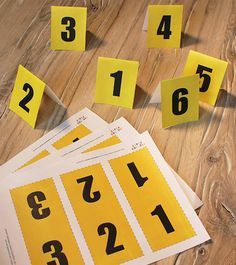 several yellow numbered numbers are on the floor next to each other and scattered around them