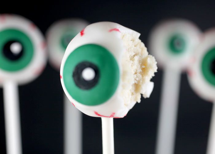 a close up of a toothpick with green eyes on it