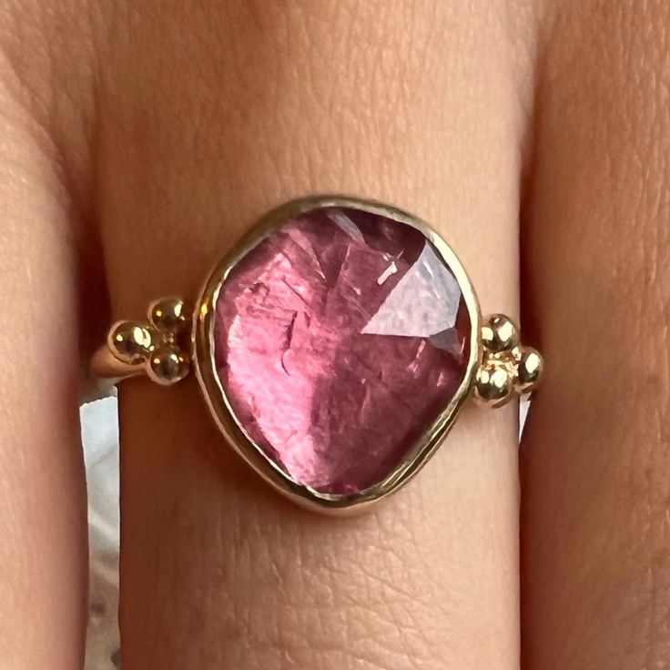 This freeform pink tourmaline is set in 14k yellow gold with gold accent beads, brilliant white diamonds and Emily's signature gold band. Approximate stone size: 12mm x 10mm Mohs Hardness: 7-7.5 Each piece is handmade with love in our Hudson Valley studio. This ring is one of a kind and currently ready to ship at size 7.5. Free resizing is available prior to shipping. Wall To Wall Carpet, Pink Stone Rings, Tourmaline Jewelry, Wall Carpet, Diamonds Ring, Local Jewelry, Funky Jewelry, Jewelry Lookbook, Gold Accent