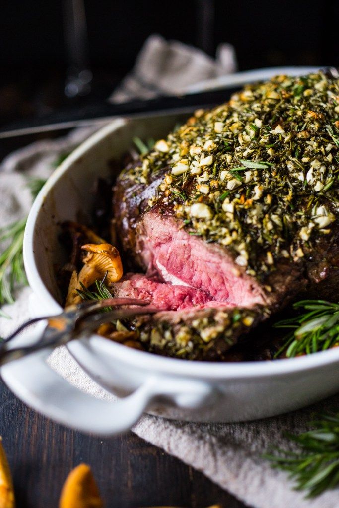 a roasting pot roast with herbs and seasonings on the side, ready to be served