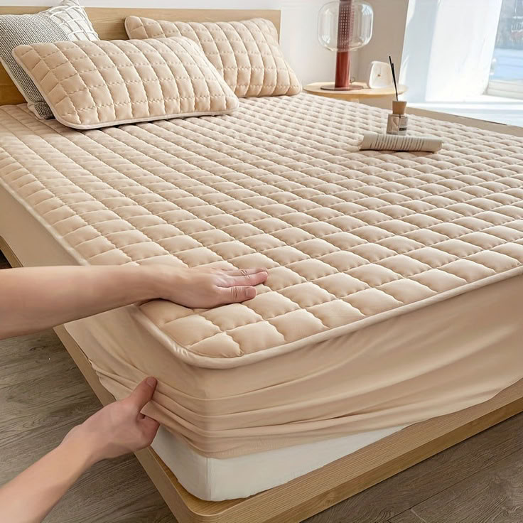 a person reaching for an unmade mattress on a bed