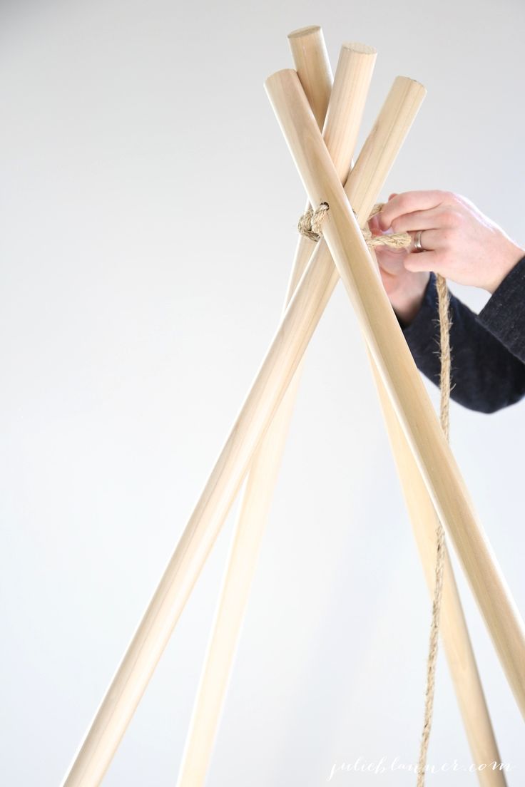 a person is holding some wood sticks together