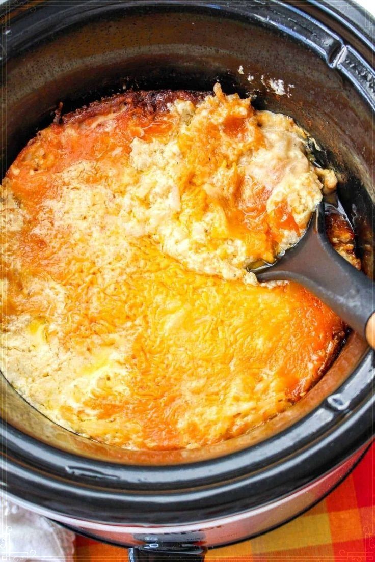 someone is spooning some food out of the crock pot to make it look like they are eating something