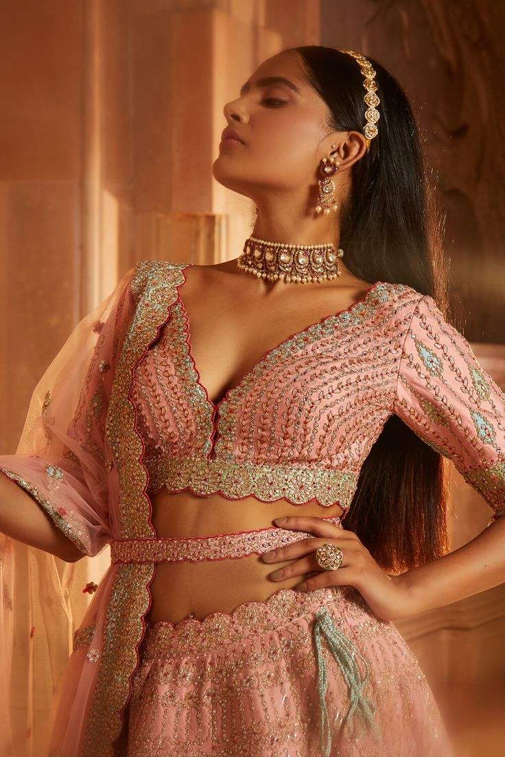 Editor's Note Peach Tafetta Lehenga Choli And Worked Belt With A Tulle Dupatta, Pastel Patchwork Intricately Embroidered With Gota, Dabka And Beadwork Color: Peach Fabric: Taffeta & Tulle Components: Lehenga, Blouse, Dupatta & Belt Care: Dry Clean Only About the Designer Nitika Gujral’s journey with designing clothes started almost four decades back while she was still in high school and held her first exhibition for family and friends. Making clothes has been a part of her life ever since. Fitted Peach Bollywood Anarkali Set, Peach Zari Work Sets For Reception, Elegant Peach Choli For Wedding, Embellished Peach Lehenga For Reception, Semi-stitched Pink Embellished Blouse Piece, Pink Semi-stitched Embellished Blouse Piece, Semi-stitched Embellished Pink Blouse Piece, Elegant Peach Embellished Sets, Elegant Embellished Peach Sets