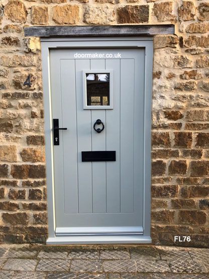 a grey door on a brick wall with the words documenter co uk written on it