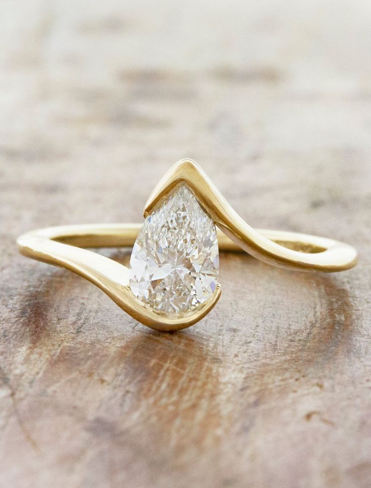 caption:Shown with 1ct pear diamond Cross Over Engagement Ring, Engagement Rings Bypass Band, Salome Engagement Ring, Modern Bezel Engagement Ring, Pear Drop Ring, Abstract Diamond Ring, Pear Shape Ring Design, Unique Pear Engagement Rings, Unique Bezel Set Engagement Ring