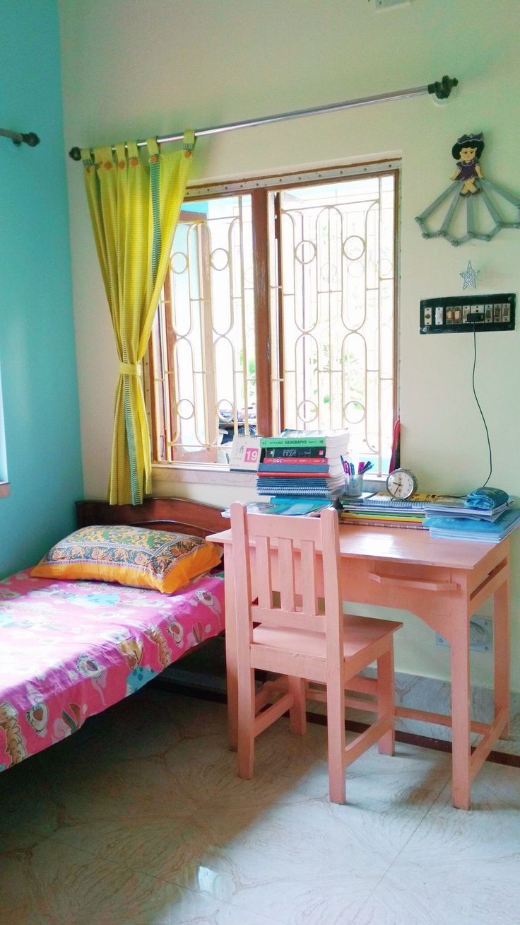 a bedroom with a bed, desk and window