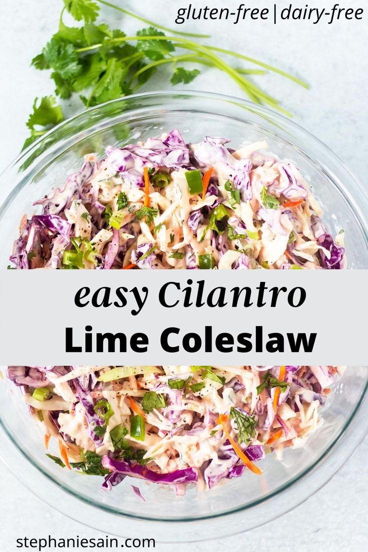 a glass bowl filled with coleslaw and garnished with cilantro