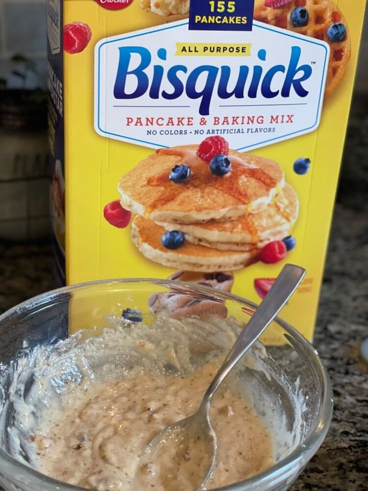 a box of biscuit pancake and baking mix next to a bowl of pancakes