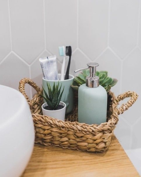 a basket with toothbrushes, soap and other items in it on a counter