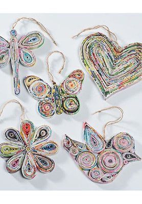 four pieces of paper are arranged in the shape of heart and butterfly shapes, with string attached to them