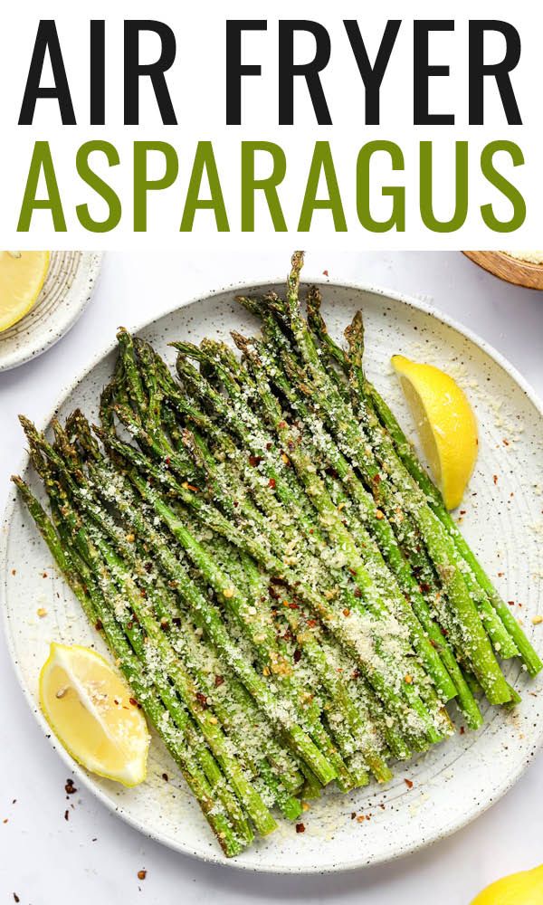 air fryer asparagus on a plate with lemons and parmesan