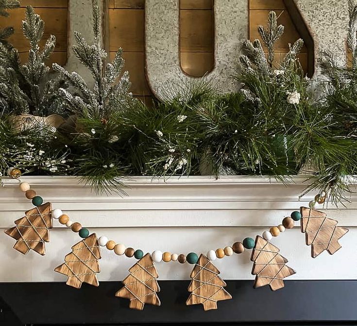 a fireplace mantle decorated for christmas with wooden decorations