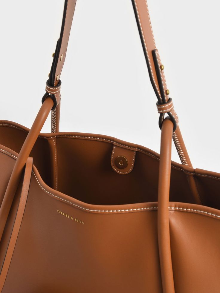 Cognac Large Stitch-Trim Slouchy Tote Bag - CHARLES & KEITH US Classic Hobo Bag With Detachable Handle In Tote Shape, Classic Hobo Tote Bag With Detachable Handle, Classic Bucket Bag With Handles, Classic Bucket Bags With Handles, Structured Travel Bag With Leather Handles, Classic Hobo Bag With Adjustable Strap, Classic Hobo Tote Bag With Adjustable Strap, Classic Bucket Bag With Handles For Travel, Classic Hobo Bag With Removable Pouch For Shopping