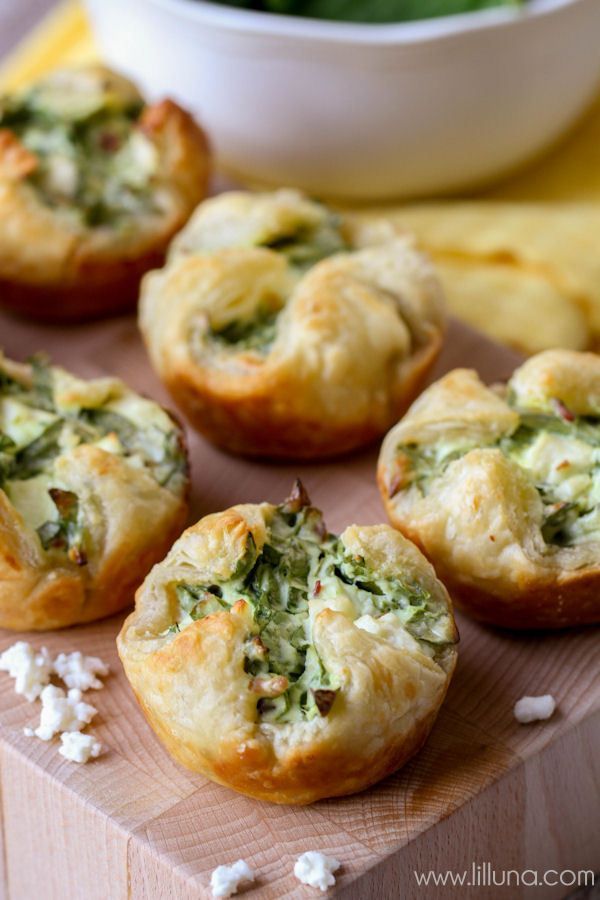 mini quiches with spinach and feta cheese on a cutting board