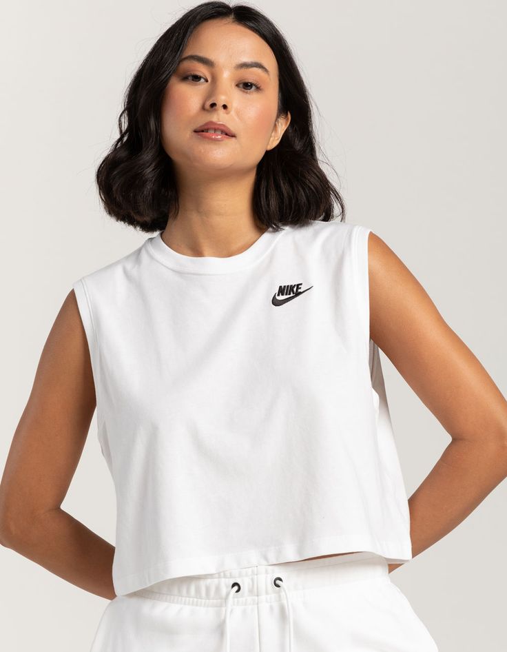 Nike Sportswear Club Crop Muscle Tee. Nike Logo Embroidered At Left Chest. Ribbed Crew Neckline. Sleeveless. Cropped And Boxy Fit. 100% Cotton. Machine Wash. Imported. Model Is Wearing A Size Small. Model Measurements:height: 5'8" Bust: 32"waist: 25"hips: 36" Muscle Shirt Women, Trendy Fitted Cropped T-shirt For Workout, Trendy Cropped T-shirt For Workout, Nike Workout Outfits, Nike Outfits For Women Summer, Muscle Tee Outfit, Cropped Muscle Tank, Affordable Sporty Cropped T-shirt, Work Out Shirts