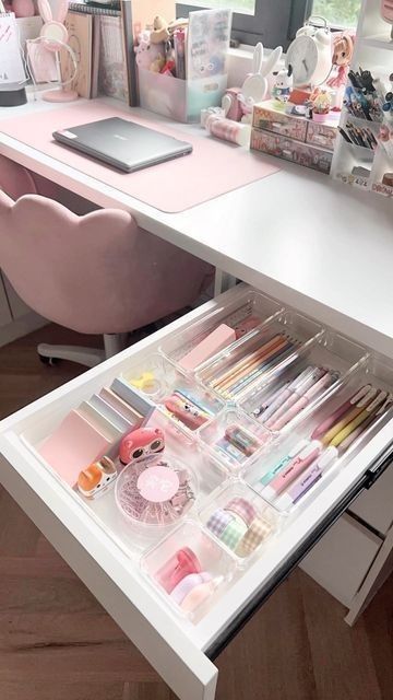 an organized drawer in the middle of a desk