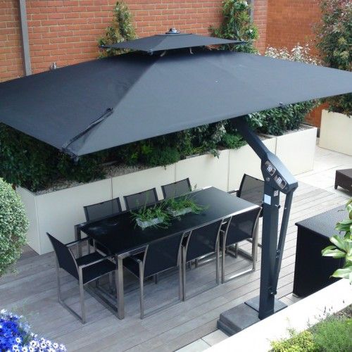 an image of a patio with table and chairs under an umbrella in the middle of it