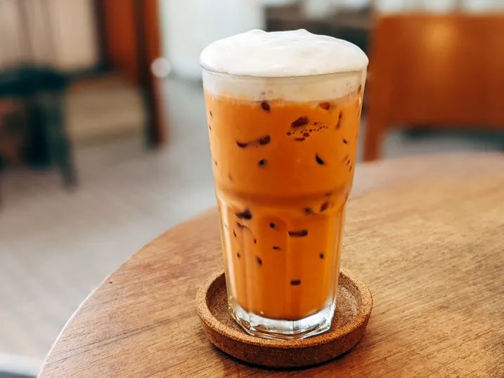 an iced drink sitting on top of a wooden table