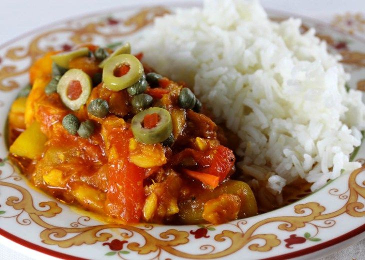 a white plate topped with rice and vegetables