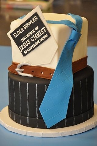 a cake with a blue ribbon on it and a sign that says elder bower the spirit of jesus christ